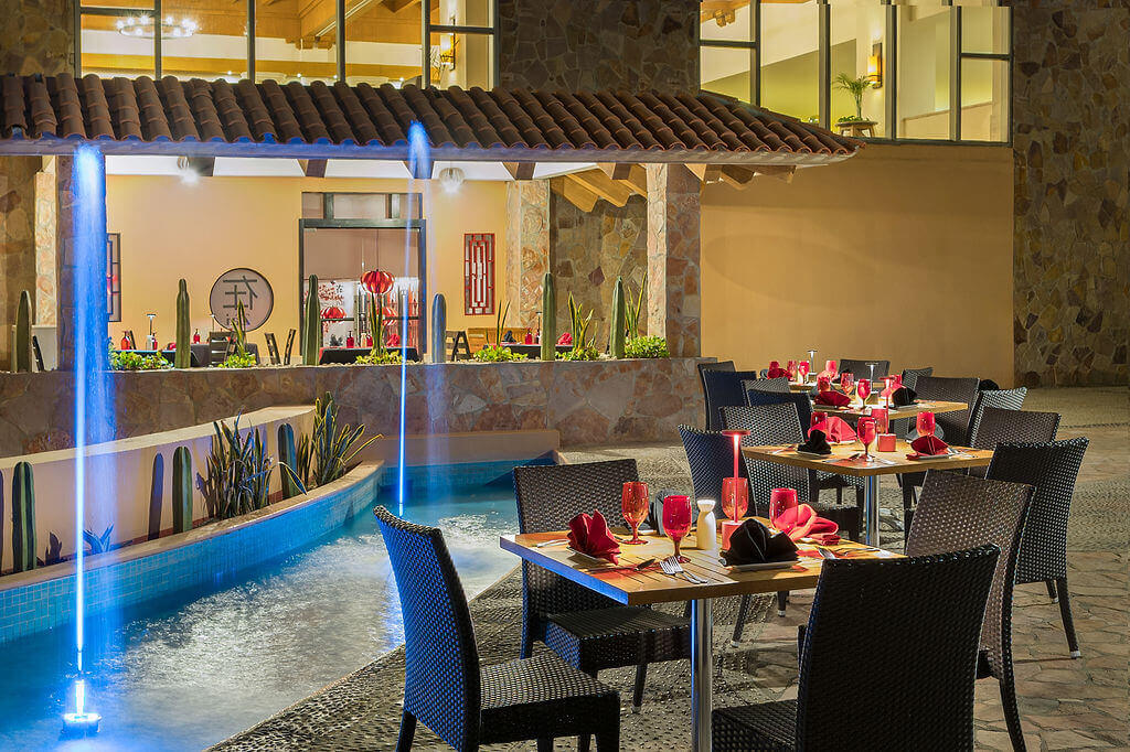 ZAI terrace with tables set by a water feature