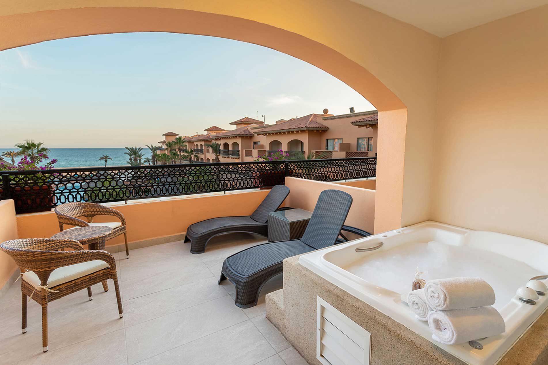 Jacuzzi on an arched terrace facing the sea at sunset